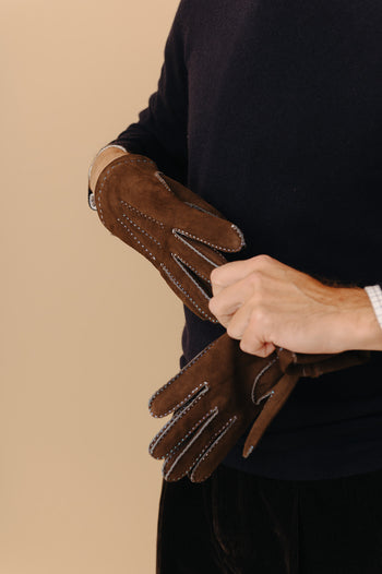 Model wearing brown gloves for menswear accessories