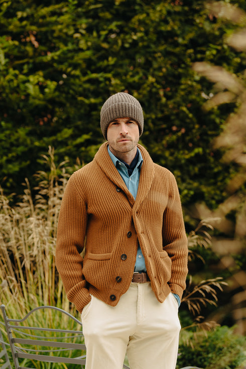 Cashmere knitted shawl cardigan in tan with knitted hat in garden