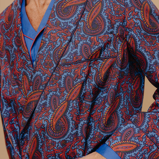 Close up image of male model against cream background wearing Men's Fine Twill Cotton Pyjamas in Royal Blue with Madder Silk Paisley Dressing Gown