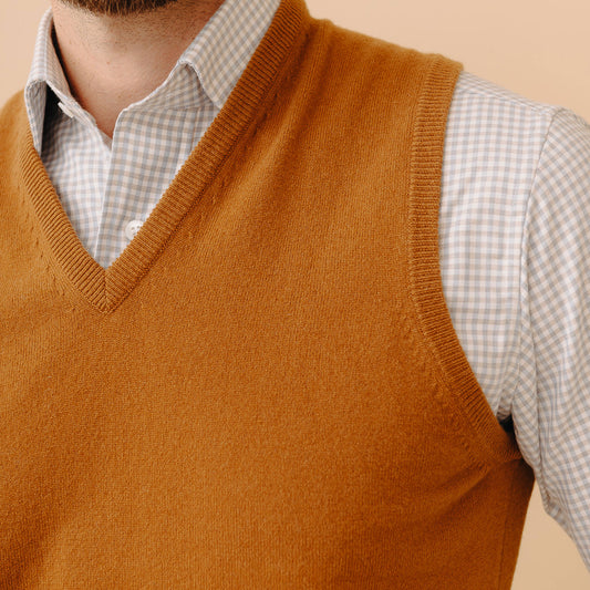 Close up image of Model wearing new Stanhope Cashmere V-Neck Slipover in Vintage Vicuna over a gingham checked shirt against cream background
