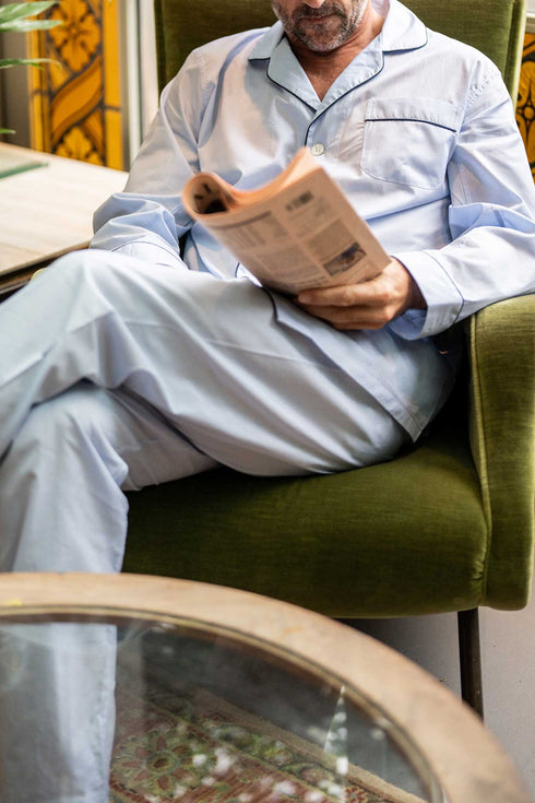 Man wearing Sky Blue Pyjamas reading the newspaper