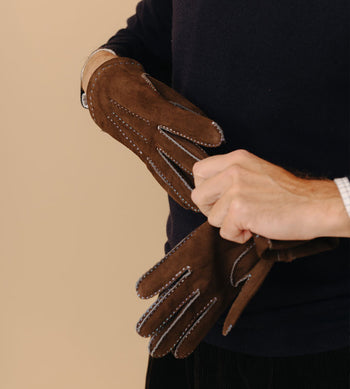 Model wearing brown gloves for menswear accessories